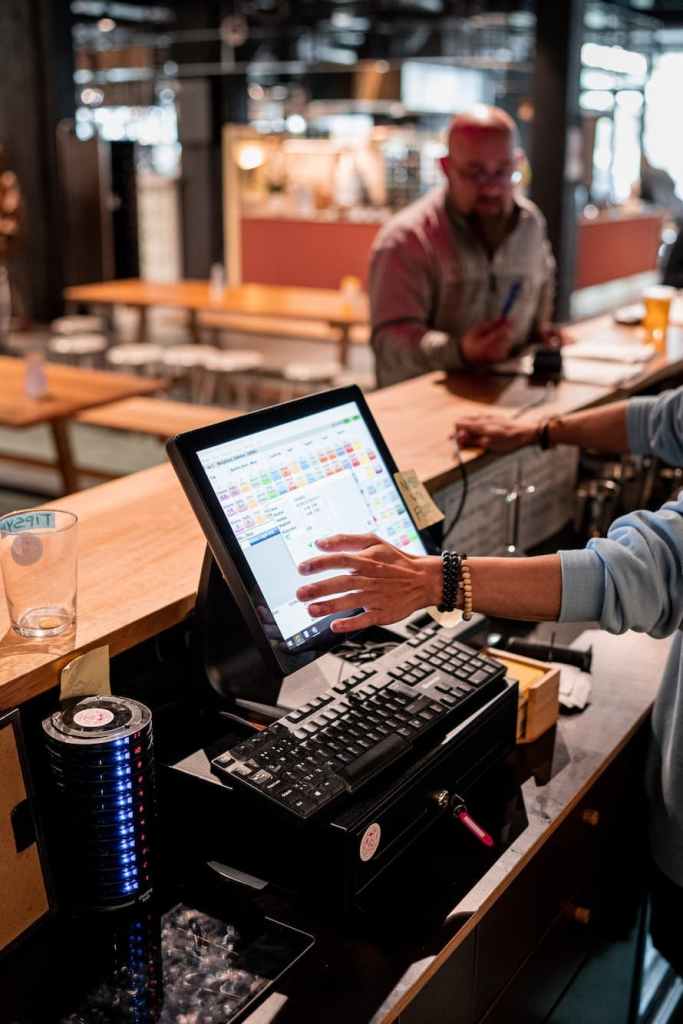 Restaurant staff using a POS system to serve customers